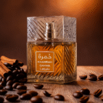 Lattafa Khamrah Qahwa perfume bottle with amber liquid on a warm background, coffee beans and cinnamon on the table.